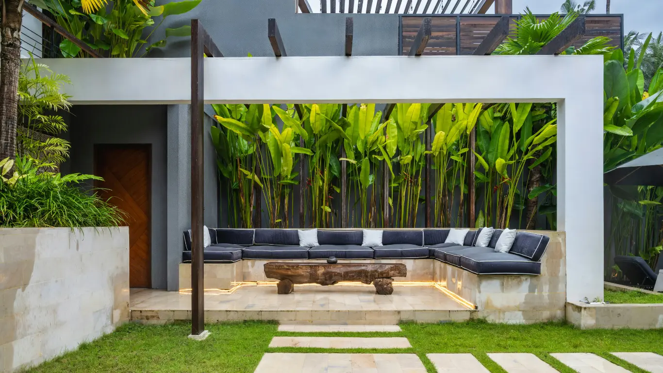 Contemporary outdoor landscape design with garden seating area by Landscape Services in Palakkad